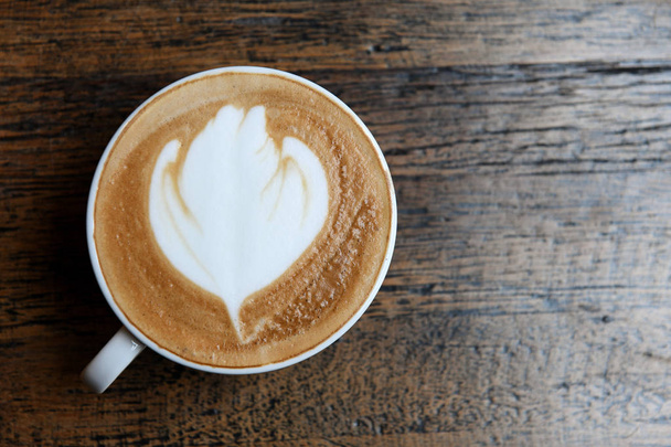 Coffee latte leaves texture on wooden floor. - 写真・画像