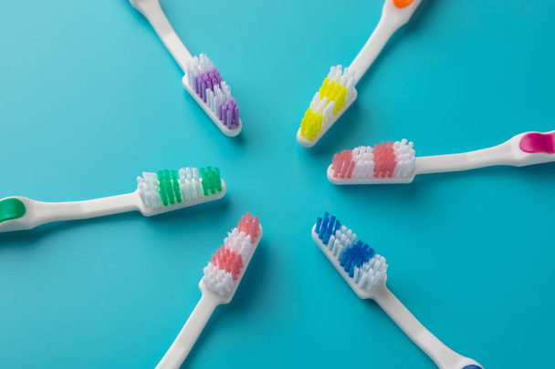 Toothbrushes on blue background. six star shaped pieces. - Zdjęcie, obraz