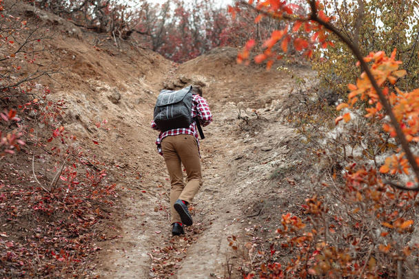 young man tourist with backpack walking on nature. - Photo, Image