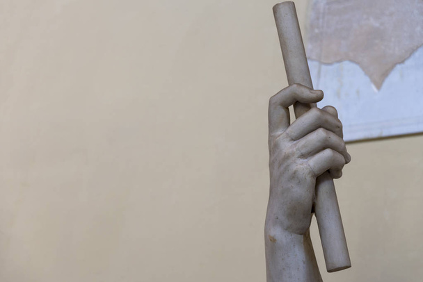 De hand van de marmeren beeldhouwwerk met een stok. Attractie Museum. - Foto, afbeelding