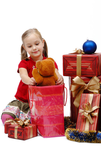 Cute little girl with Christmas gifts on a white background, isolated - Foto, Bild