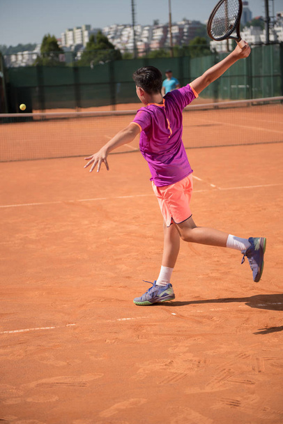 Young tennis player playing backhand - Фото, зображення