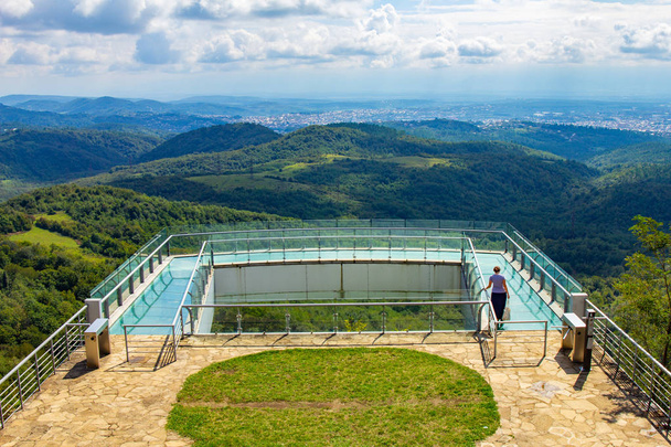 Kutaisi, Georgia caucasus region. Beautiful view to glass bottomed Observation Platform With Clear Floor At Highest Point Of State Sataplia Reserve With Wonderful View Of Kutaisi And Its Surroundings. - Photo, Image