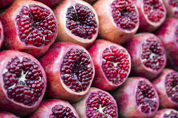 many pomegranate cut in half, pomegranate background. Selective focus - Fotografie, Obrázek