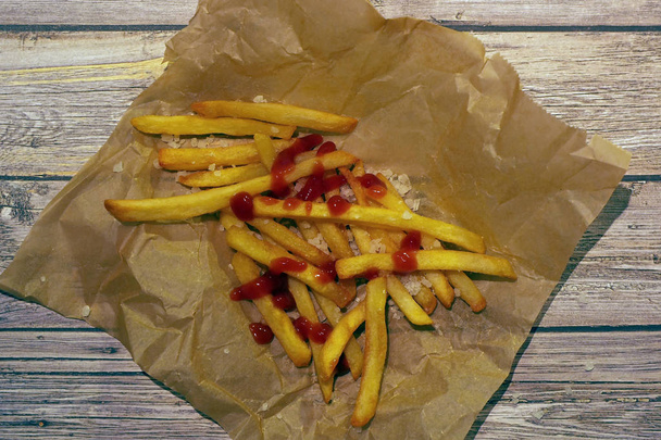 French fries with ketchup and salt grains - Photo, image