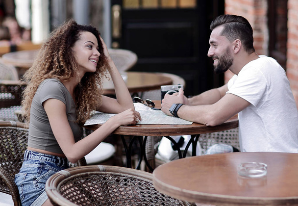 Beautiful loving couple sitting in a cafe enjoying in coffee - Photo, image