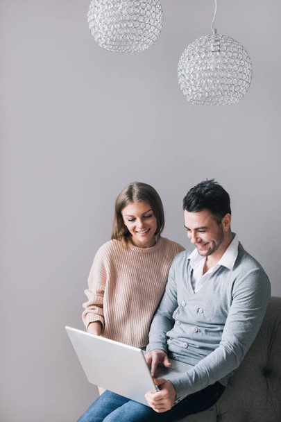 Happy couple looking at laptop. Choice. - Fotó, kép