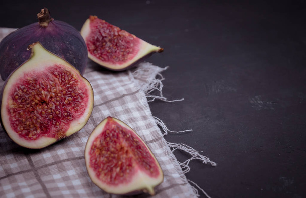 Fresh figs. Food Photo. Creative scheme of the whole and sliced figs on a white background, inscribed in a rectangle. View from above. - Photo, image