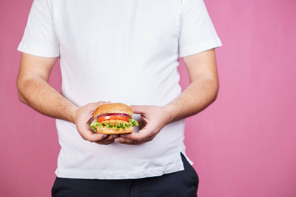 glutton man eating burger, unhealthy diet - Фото, изображение