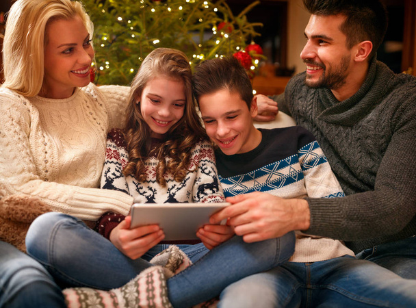 Happy family time smiling family using digital tablet on Christmas holiday - Fotoğraf, Görsel