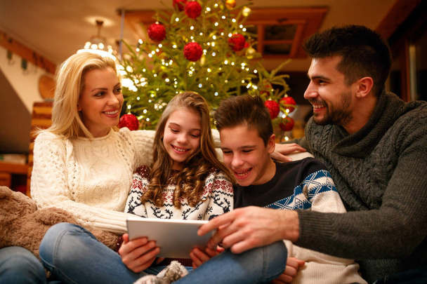 family fun time on Christmas at home with digital tablet - Φωτογραφία, εικόνα
