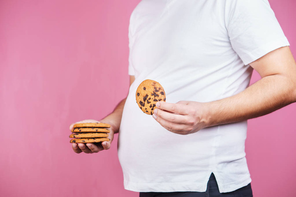 sugar addiction, obese man with stack of cookies - Foto, imagen