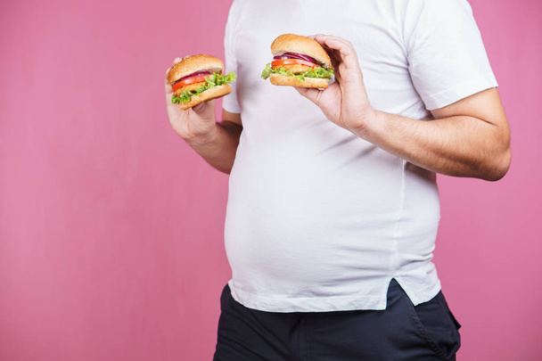 fast food and weight gain. fat man with burgers - Fotó, kép