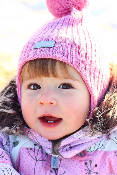 child outside on the field in winter in warm clothes - Photo, image