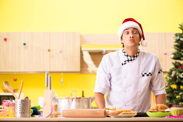 Young chef husband working in kitchen at Christmas eve  - Foto, Bild