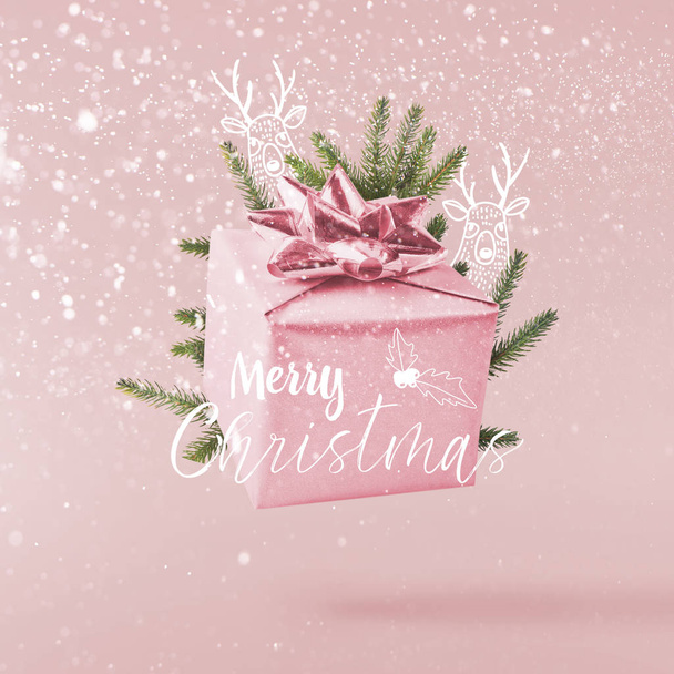 Christmas concept.  Creative Christmas conception made by falling in air silver gift box over pink background. Minimal concept - Foto, immagini