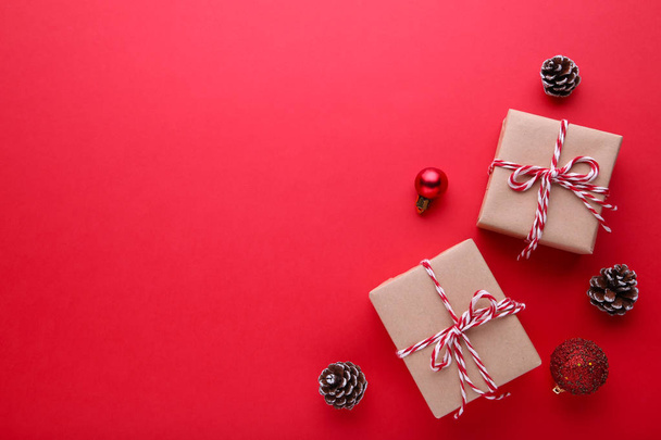 Gift presents box with christmas decor on a red background, flat lay - Foto, immagini