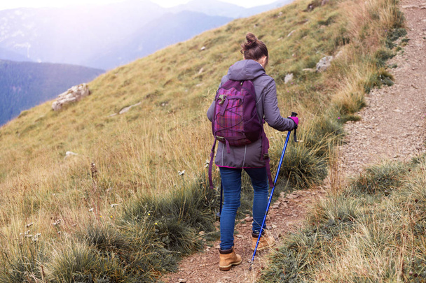 girl hiker walking along the trail at the mountains Dolomites, Ital - Photo, Image