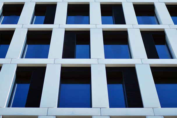 Fragment of a facade of a building with windows and balconies. Modern home with many flats. - Φωτογραφία, εικόνα