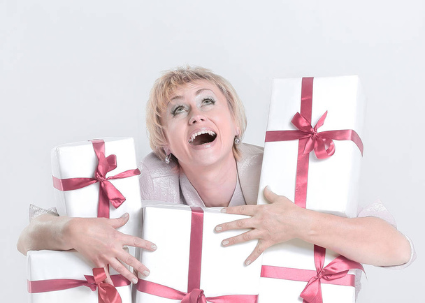 closeup.very happy woman with gift boxes. isolated on a white background - Zdjęcie, obraz