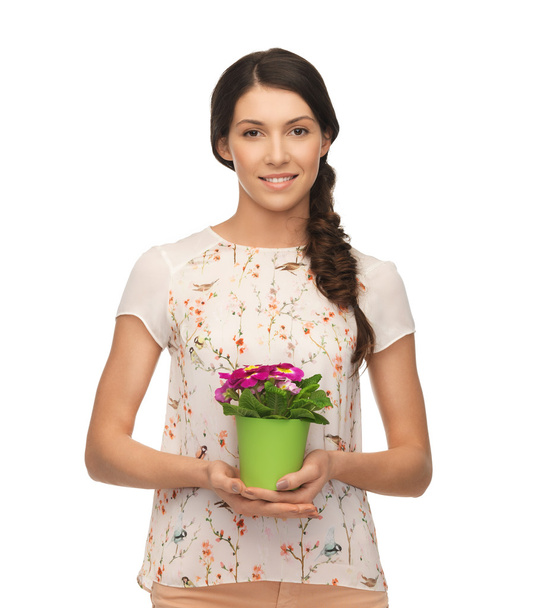 Lovely housewife with flower in pot - Zdjęcie, obraz