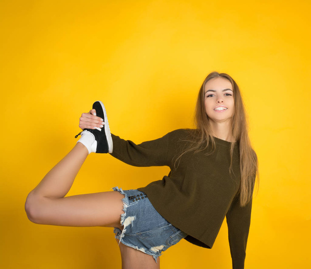 Ecstatic blond young woman in jeans shorts - Фото, изображение