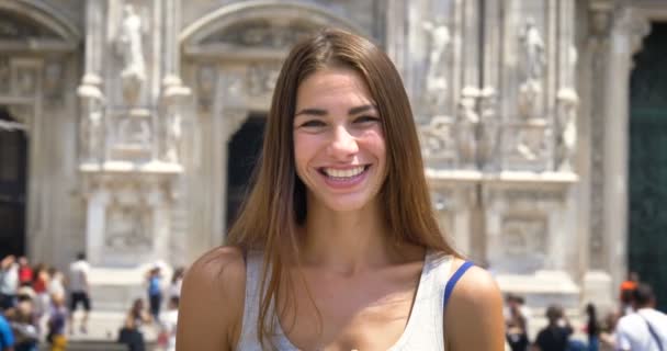 Beautiful young tourist girl (woman) in Milan, writes a message, talking on the phone, happy smiling, background Milan gallery. Concept: tourism, love to travel, communication, freedom, love life. - Materiał filmowy, wideo
