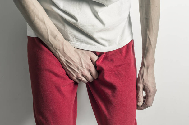 Prostate concept, inflammation of the bladder. Premature ejaculation. Man holding penis. - Foto, Imagem
