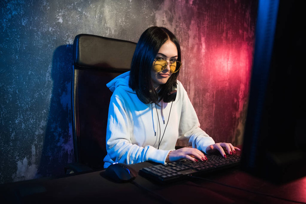 girl gamer wearing headphone playing network games preparing to participate in international competitions in esports - Фото, зображення