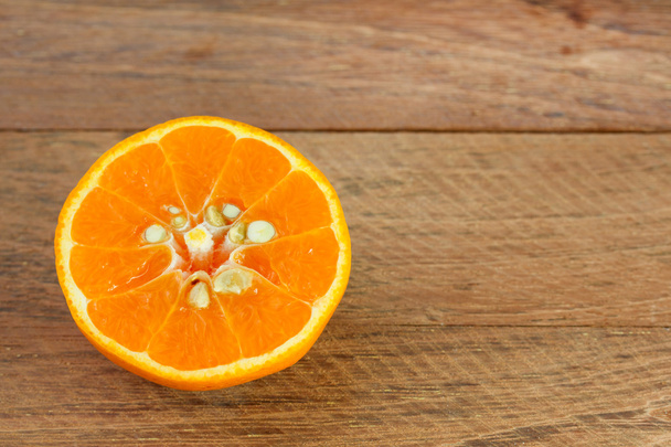 half orange on wooden table - Foto, Bild