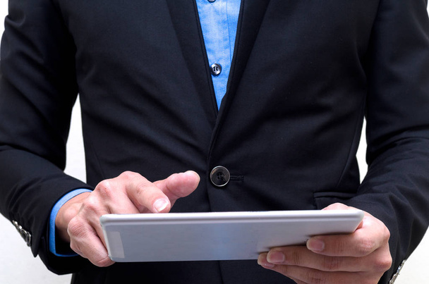 Businessman using tablet with isolated on white background. - Valokuva, kuva