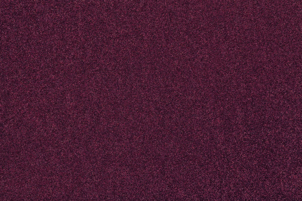 Темно-фіолетовий матовий фон з замшевої тканини, крупним планом. Оксамитова текстура безшовного винного вовняного фетру
. - Фото, зображення