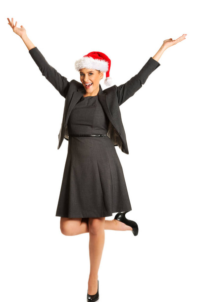 Happy businesswoman wearing christmas hat - Foto, imagen