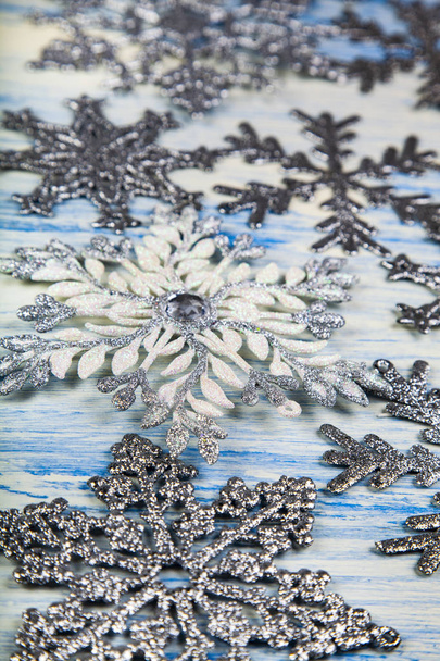 Christmas snowflakes on blue wooden background.  - Fotografie, Obrázek