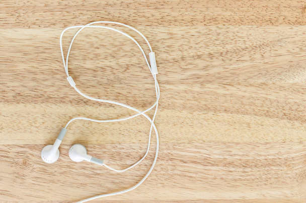 earbuds or earphones on wood background - Photo, Image