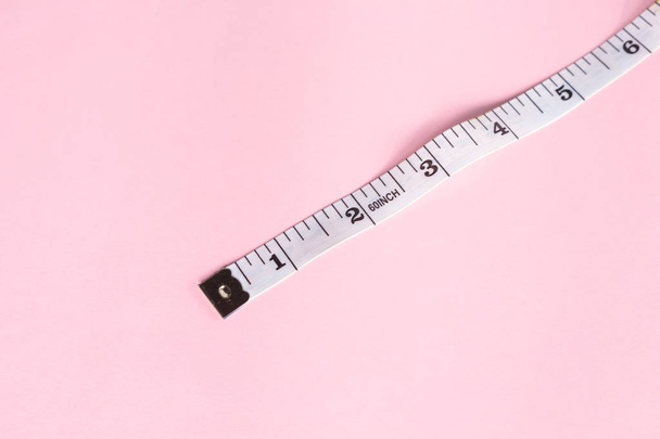 measure tape tool of sewing work on pink background. - Photo, Image