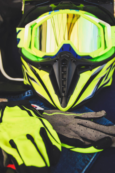 Cross helmet, gloves yellow fluorescent. Equipment for motorcycles. Enduro on the trip. - Photo, Image