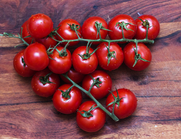 small tomatoes, sherry on a wooden board. - Фото, зображення