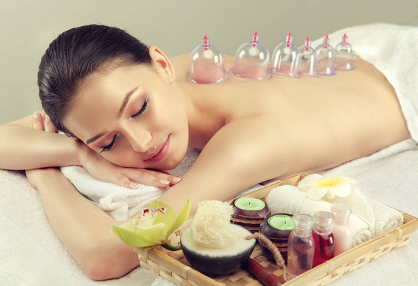 Beautiful woman relaxing in spa salon with vacuum body massage - Photo, Image