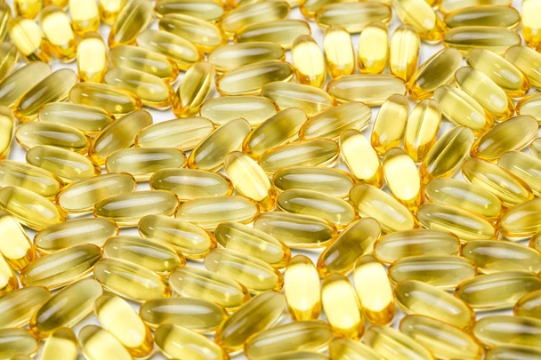 Photo background of yellow healthy vitamin d in pills - Foto, Imagem