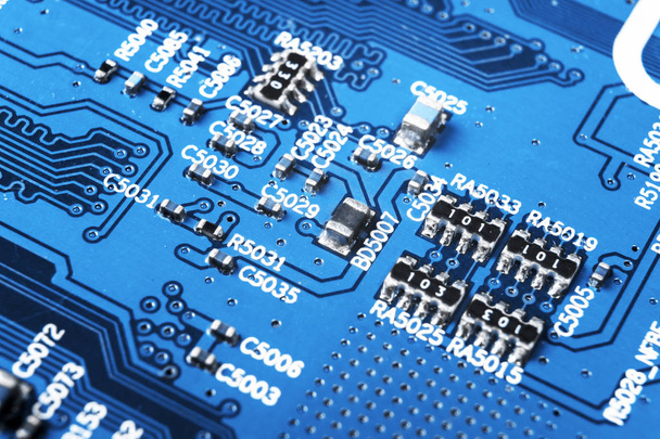 Macro shot of a Circuitboard with resistors microchips and electronic components. Computer hardware technology. Integrated communication processor. Information engineering. Semiconductor. PCB. Closeup - Фото, зображення