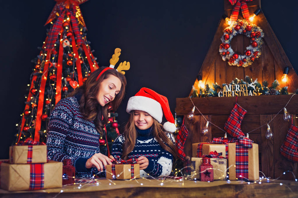 a happy family mother and child pack Christmas gifts - Foto, Imagem