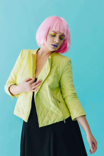 Beautiful young woman with pink hair on blue background - 写真・画像