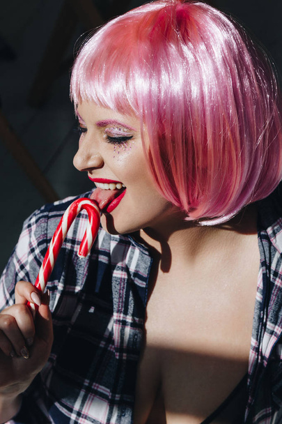Beautiful young woman with pink hair and lollipop - Foto, Imagen