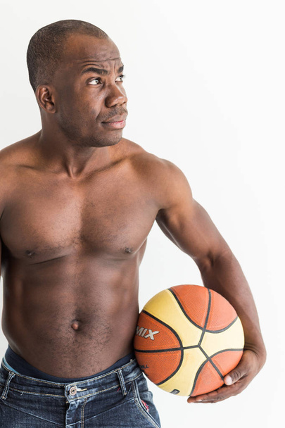 Muscular afro american athlete with basketball ball on white background - Foto, Imagem