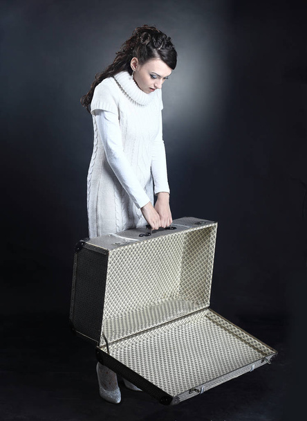 upset young woman with an empty suitcase - Zdjęcie, obraz