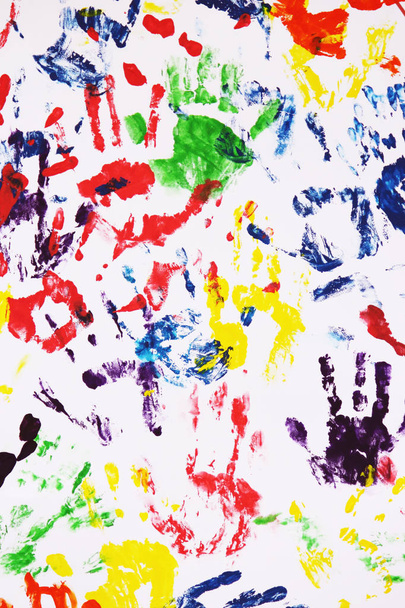 colorful handprints on the white background as symbol of teamwork - Photo, image