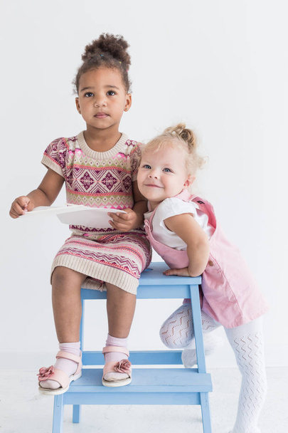 Two little girls playing on a white background - Photo, Image