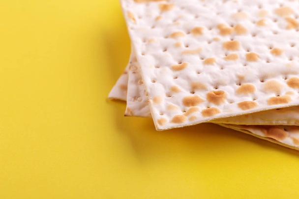 Traditional Jewish kosher matzo on bright yellow background. Copy space. Top view - Фото, изображение