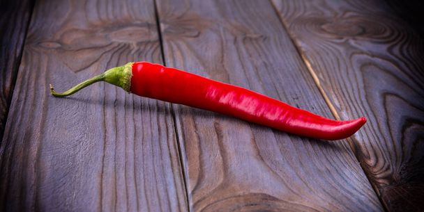 Red hot chili peppers on wooden background - Photo, image